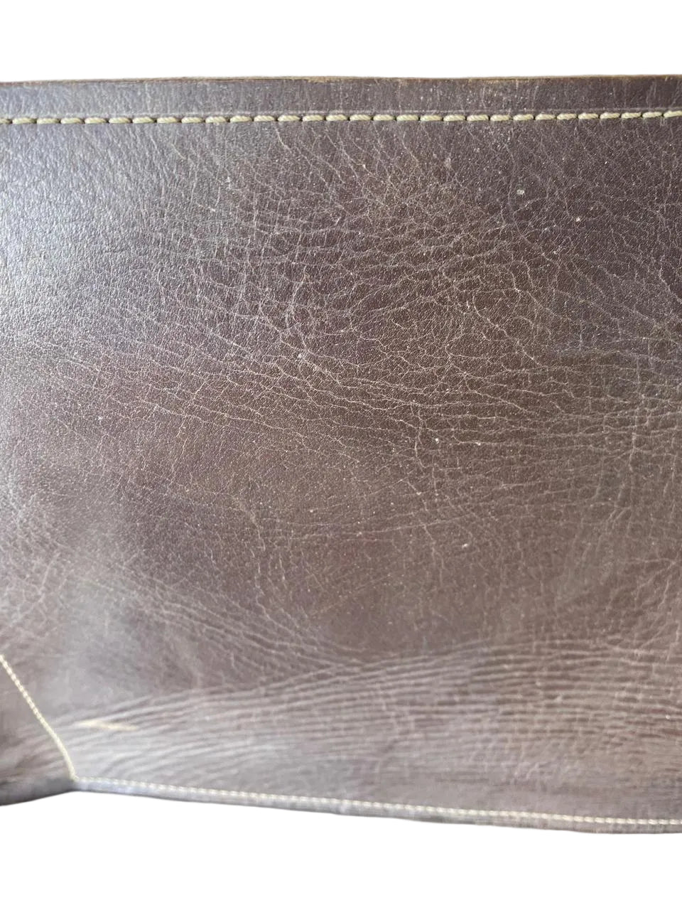 Close-up of brown leather surface with visible stitching