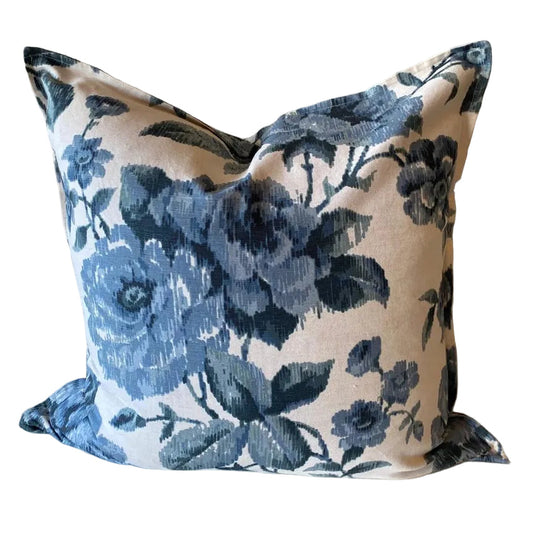 Floral patterned pillow with blue flowers on a beige background