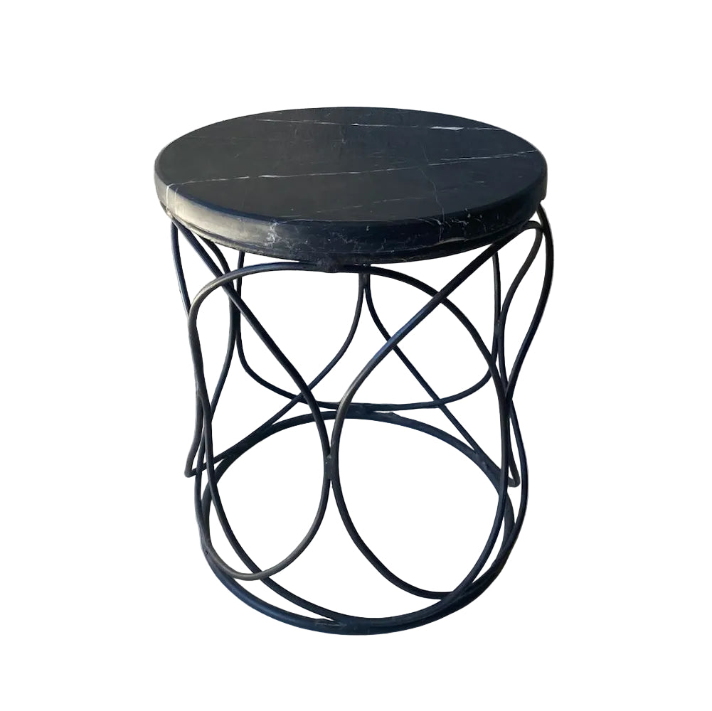 Small round black metal table with a marble top side stool
