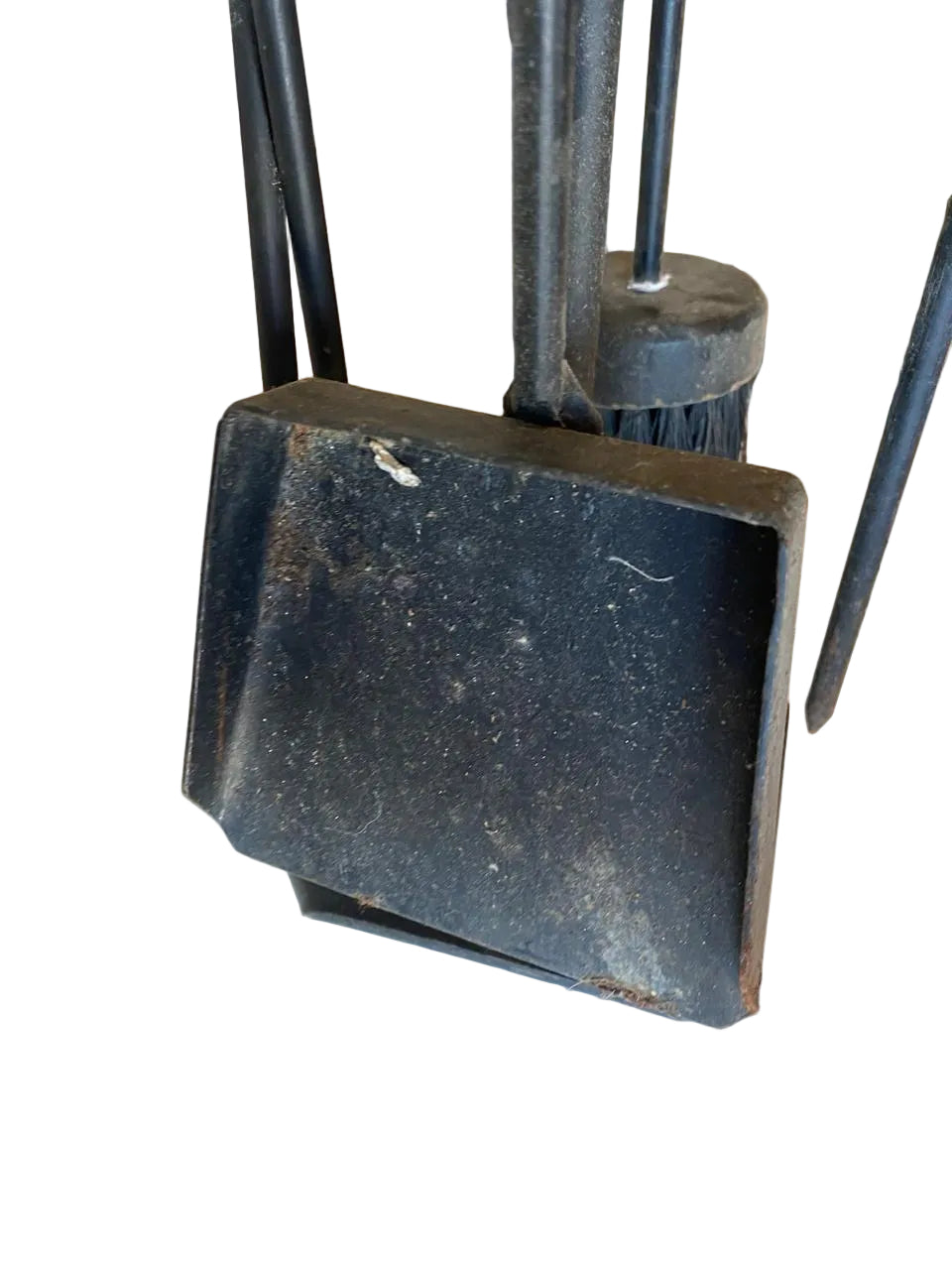 Black metal dustpan on a tiled floor