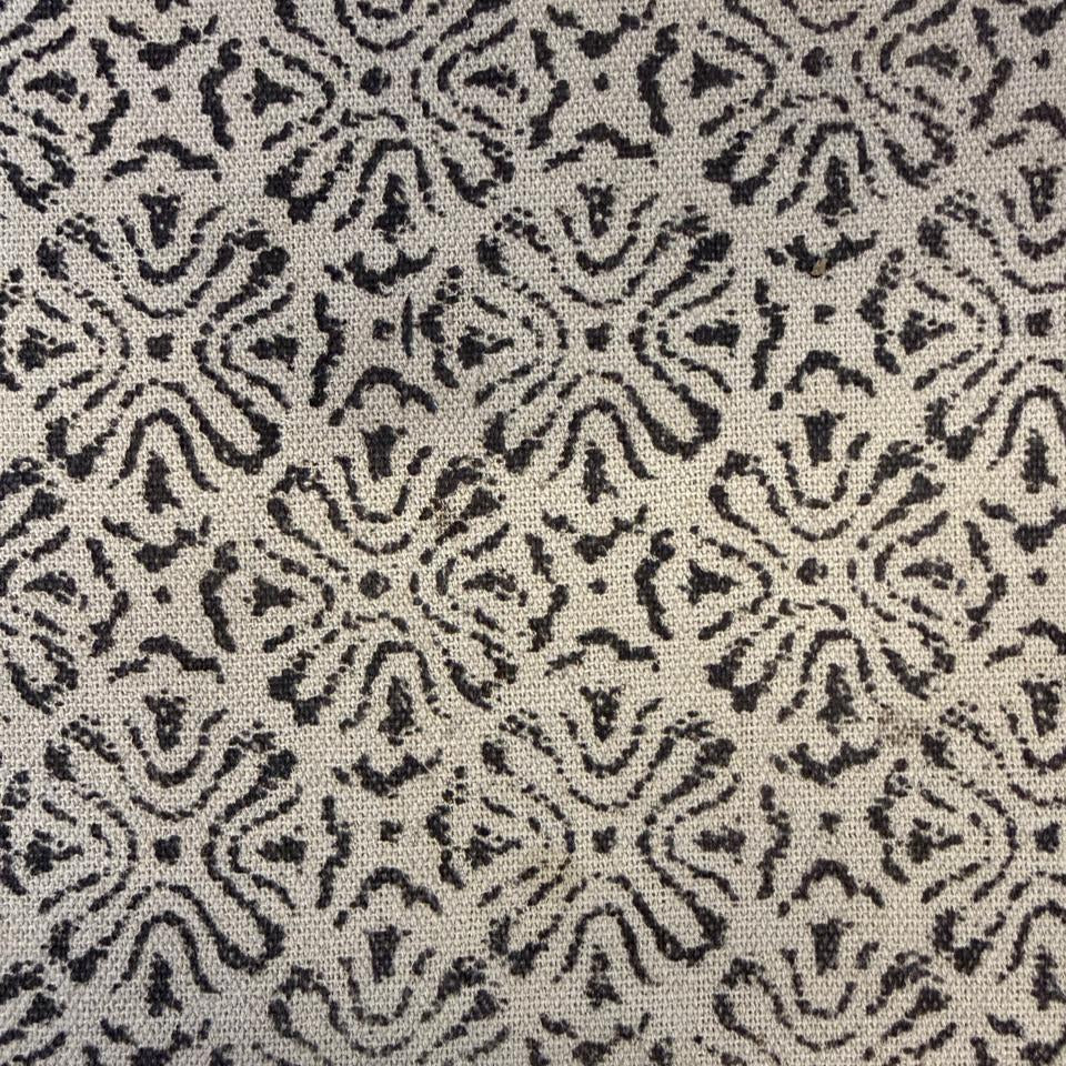 Patterned fabric with black and white design on a textured background