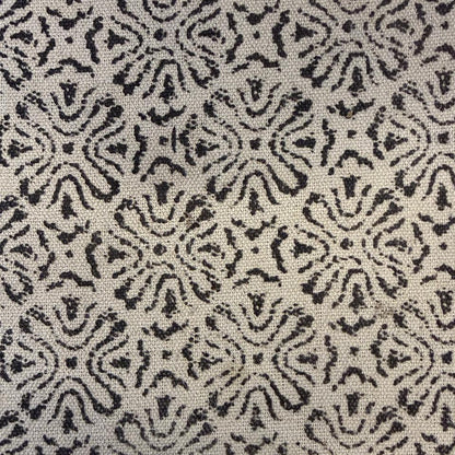 Patterned fabric with black and white design on a textured background
