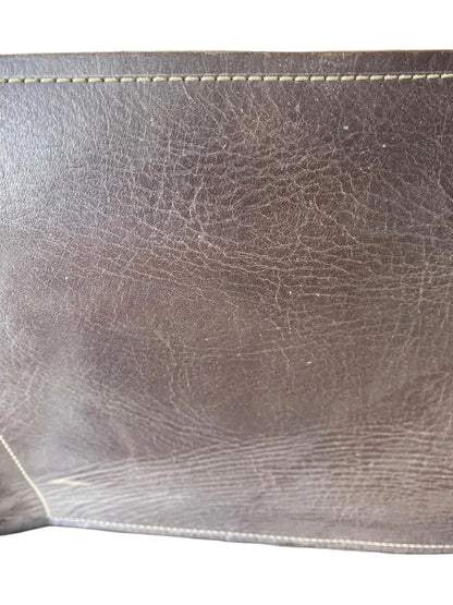 Close-up of brown leather surface with visible stitching