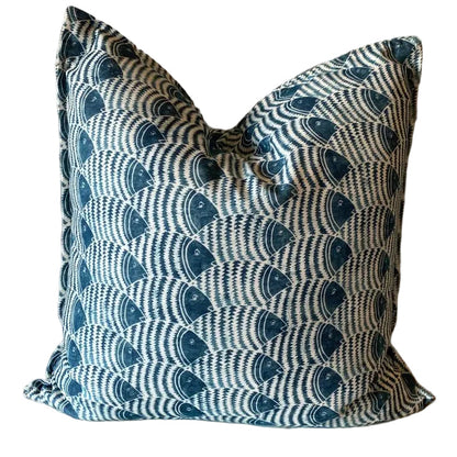 Decorative pillow with blue and white pattern on a beige surface