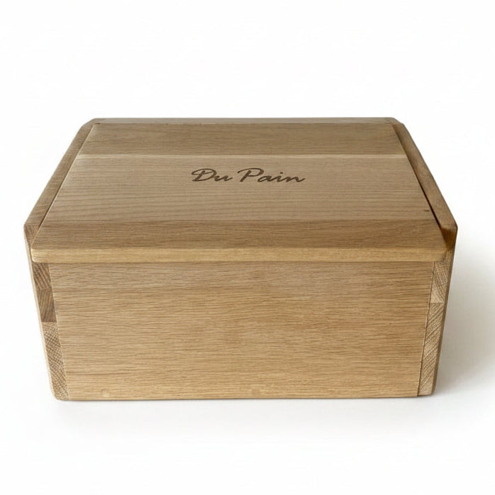 Wooden bread box with 'Du Pain' engraving on a light background