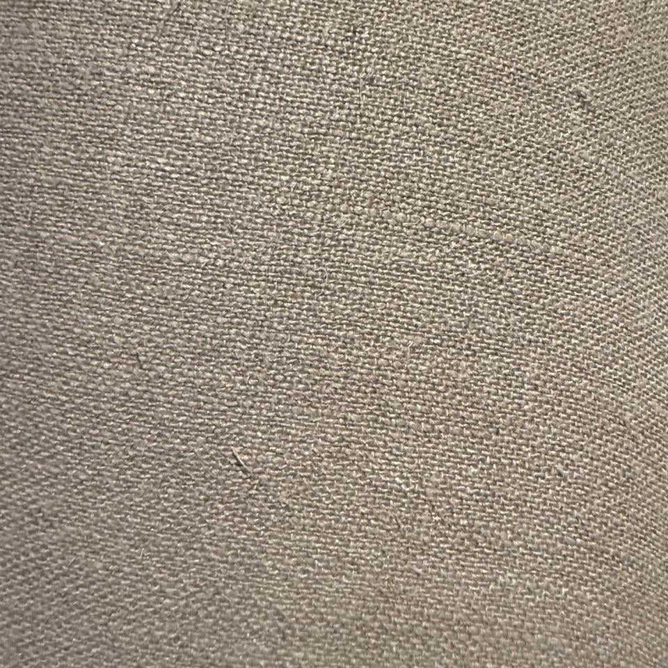 Close-up of a textured beige fabric surface lamp shade