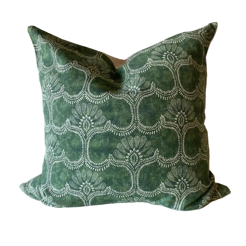 Green patterned pillow on a white surface
