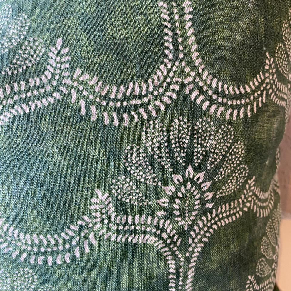 Green fabric with white floral pattern